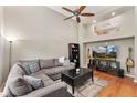Bright living room boasts hardwood floors, a vaulted ceiling, and a cozy sectional sofa for relaxing and entertaining at 9503 Longs Peak Dr, Commerce City, CO 80640