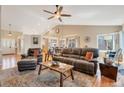Spacious living room with a vaulted ceiling, hardwood floors, and comfortable leather seating creating a relaxing atmosphere at 2533 W 110Th Ave, Westminster, CO 80234
