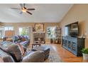 Inviting living room with a fireplace, hardwood floors, and comfortable leather seating creating a cozy atmosphere at 2533 W 110Th Ave, Westminster, CO 80234