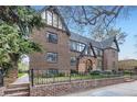Charming brick apartment building featuring a Tudor style, lush yard, and entry courtyard at 2233 Kearney St # 19, Denver, CO 80207