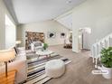Bright living room with neutral tones, vaulted ceiling, and elegant furnishings, staged to impress at 18945 E 45Th Ave, Denver, CO 80249