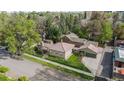 An aerial view displays a traditional home featuring a clay tile roof and a detached garage at 1090 E 3Rd Ave, Denver, CO 80218