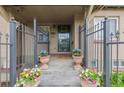 Welcoming front porch enhanced with potted plants and a wreath on the door, framed by a secure metal fence at 1090 E 3Rd Ave, Denver, CO 80218