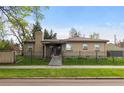 Beautiful home featuring a well-maintained lawn, brick exterior, and wrought iron fence at 1090 E 3Rd Ave, Denver, CO 80218