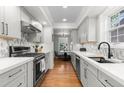 Modern kitchen with stainless steel appliances, white countertops, and stylish backsplash at 1090 E 3Rd Ave, Denver, CO 80218
