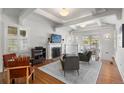 Bright living room featuring a fireplace, exposed beams, and hardwood floors at 1090 E 3Rd Ave, Denver, CO 80218