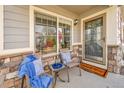 Cozy front porch featuring comfortable seating, stylish decor, and a welcoming entryway at 14332 Craftsman Way, Broomfield, CO 80023