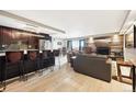 Open concept floorplan featuring living room fireplace, kitchen island and sliding doors to balcony at 2 Adams St # 705, Denver, CO 80206