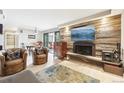 Bright living room offering a fireplace, access to the balcony, and is adjacent to the dining area at 2 Adams St # 705, Denver, CO 80206