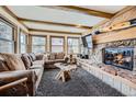 Cozy living room with stone fireplace, wooden accents, and comfortable seating at 107 N Harris St # 111, Breckenridge, CO 80424