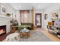 Stylish living room with a fireplace, modern furnishings, and ample natural light creating a comfortable living space at 3942 Alcott St, Denver, CO 80211