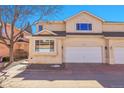 Front exterior view of home with stucco siding, arch feature over the garage and front walkway at 12420 E Iliff Pl, Aurora, CO 80014