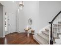 Bright foyer with hardwood floors, a staircase, a bench and ample natural light from the door and sidelight windows at 2749 Pemberly Ave, Highlands Ranch, CO 80126