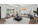 Bright living room with large windows, a ceiling fan, and modern furniture at 2989 S Corona St, Englewood, CO 80113