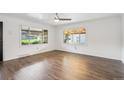 Bright living room featuring hardwood floors, a ceiling fan, and large windows at 2989 S Corona St, Englewood, CO 80113