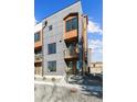A modern townhome with a mixed material facade, multiple balconies, and contemporary design at 3017 W 53Rd Ave, Denver, CO 80221