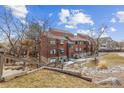 A full view of the exterior of this townhouse showcasing its multi-story architecture and surrounding landscape at 343 W Lehow Ave # 22, Englewood, CO 80110