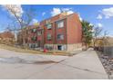 Exterior view of the building featuring a combination of wood and stone architecture with the driveway in the foreground at 343 W Lehow Ave # 22, Englewood, CO 80110
