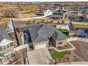 Wide aerial view of home with a large manicured lawn and a 3-car garage in a neighborhood setting at 20783 E 50Th Pl, Denver, CO 80249