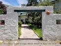 The entrance features a decorative sun decoration, stucco walls, and lush landscaping at 8828 E Florida Ave # 103, Denver, CO 80247