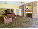 Inviting community lounge with a cozy fireplace, plush seating, and ample natural light at 8828 E Florida Ave # 103, Denver, CO 80247