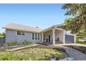 Beautiful one-story home with a covered front porch, manicured lawn, and attractive landscaping at 10890 Stuart Ct, Westminster, CO 80031