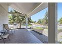 Cozy covered porch with chairs and a small table, offering a peaceful outdoor living space at 10890 Stuart Ct, Westminster, CO 80031