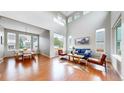 Sun-drenched living room with soaring ceilings, hardwood floors, and stylish modern furnishings for comfortable living at 5640 S Marshall St, Denver, CO 80123
