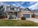 Two-story home with stone accents and a covered porch, set in a well-maintained yard at 14669 Eagle River Run, Broomfield, CO 80023