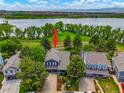 Aerial view of a lakeside home with a well-manicured yard and mature trees at 7955 S Bemis St, Littleton, CO 80120