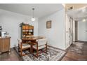 Cozy dining area featuring a wood table, four chairs, overhead lighting, and hardwood floors at 8600 E Alameda Ave # 21-208, Denver, CO 80247