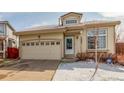 Inviting single-Gathering home featuring an attached two-car garage and a welcoming front entrance at 4602 Genoa St, Denver, CO 80249