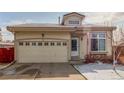 Inviting single-Gathering home featuring an attached two-car garage and a welcoming front entrance at 4602 Genoa St, Denver, CO 80249
