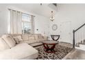 Bright living room features a large window, hardwood floors, and a neutral color palette at 4602 Genoa St, Denver, CO 80249