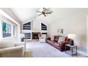 Bright living room features a cozy fireplace, built-in shelves, and a large window at 982 E 130Th Cir, Thornton, CO 80241