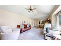 Bright living room includes an open layout with a ceiling fan and view of dining area at 982 E 130Th Cir, Thornton, CO 80241