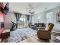 Cozy living room with plush seating, a sliding door to the backyard, and modern decor for a relaxing atmosphere at 9679 Waco St, Commerce City, CO 80022