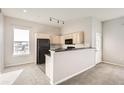Bright kitchen featuring neutral paint, light cabinets, and black appliances at 15475 Andrews Dr # 401, Denver, CO 80239
