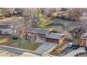 Aerial view of home featuring a spacious yard, mature trees, and convenient three car garage at 8061 S Kendall Blvd, Littleton, CO 80128