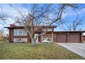 Charming two-story home featuring an attached two-car garage and well-maintained front lawn at 8061 S Kendall Blvd, Littleton, CO 80128