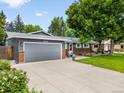 Spacious driveway leading to a two-car garage, complemented by well-maintained landscaping at 602 Birch St, Broomfield, CO 80020