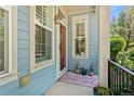 Inviting front porch with blue siding, stylish decor, and a cozy welcome at 8189 E 29Th Ave, Denver, CO 80238