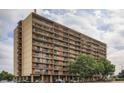 A daytime exterior view of the building showcasing its architectural design and multiple levels with balconies at 2225 Buchtel Blvd # 105, Denver, CO 80210