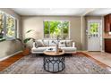 Bright living room features a large window, hardwood floors, and modern furniture at 3925 Pecos St, Denver, CO 80211
