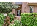 Charming front entrance to a brick townhouse featuring well-maintained landscaping at 476 S Saulsbury St, Lakewood, CO 80226