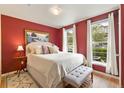 Cozy main bedroom showcasing hardwood floors, bright windows, and warm red walls at 476 S Saulsbury St, Lakewood, CO 80226