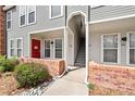 Exterior showcasing the entrances of multiple townhomes with brick accents and well-kept landscaping at 1150 Inca St # 25, Denver, CO 80204