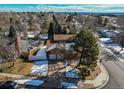 Suburban home featuring a spacious backyard with mature trees and a fenced-in yard at 5894 S Oak St, Littleton, CO 80127