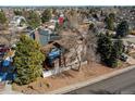 This house boasts mature trees and a fenced yard in a suburban neighborhood at 5894 S Oak St, Littleton, CO 80127