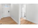 Bright entryway featuring wood-look flooring and crisp white trim, leading to various rooms within the home at 16975 W 92Nd Loop, Arvada, CO 80007